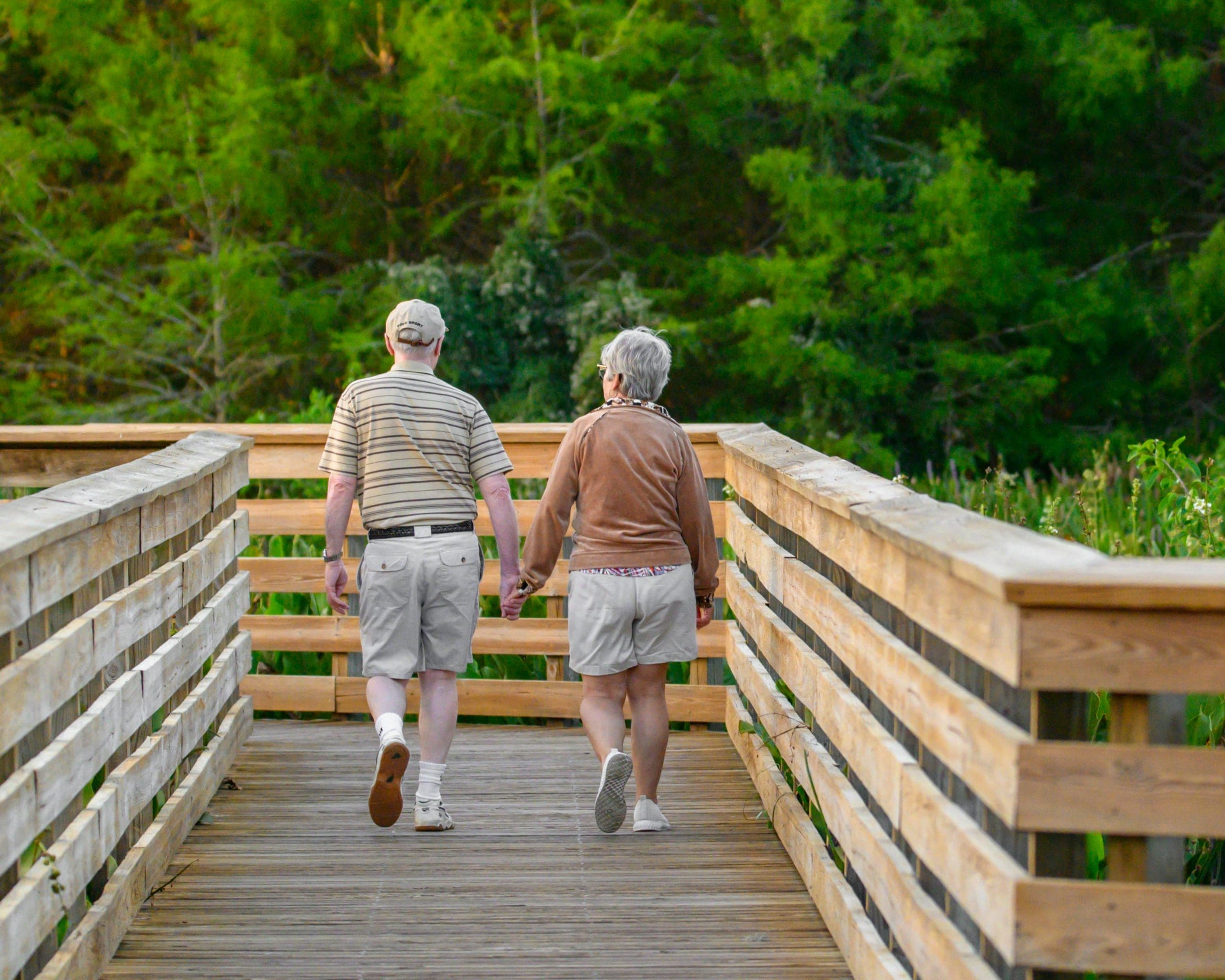A couple walking together across a bridge